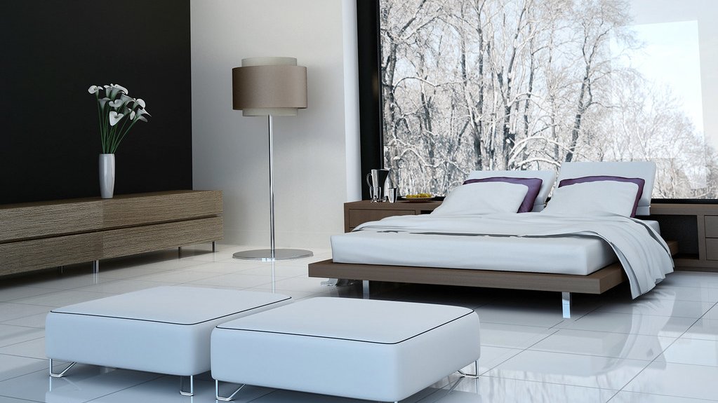 Chambre moderne avec un grand lit et une vue sur des arbres enneigés